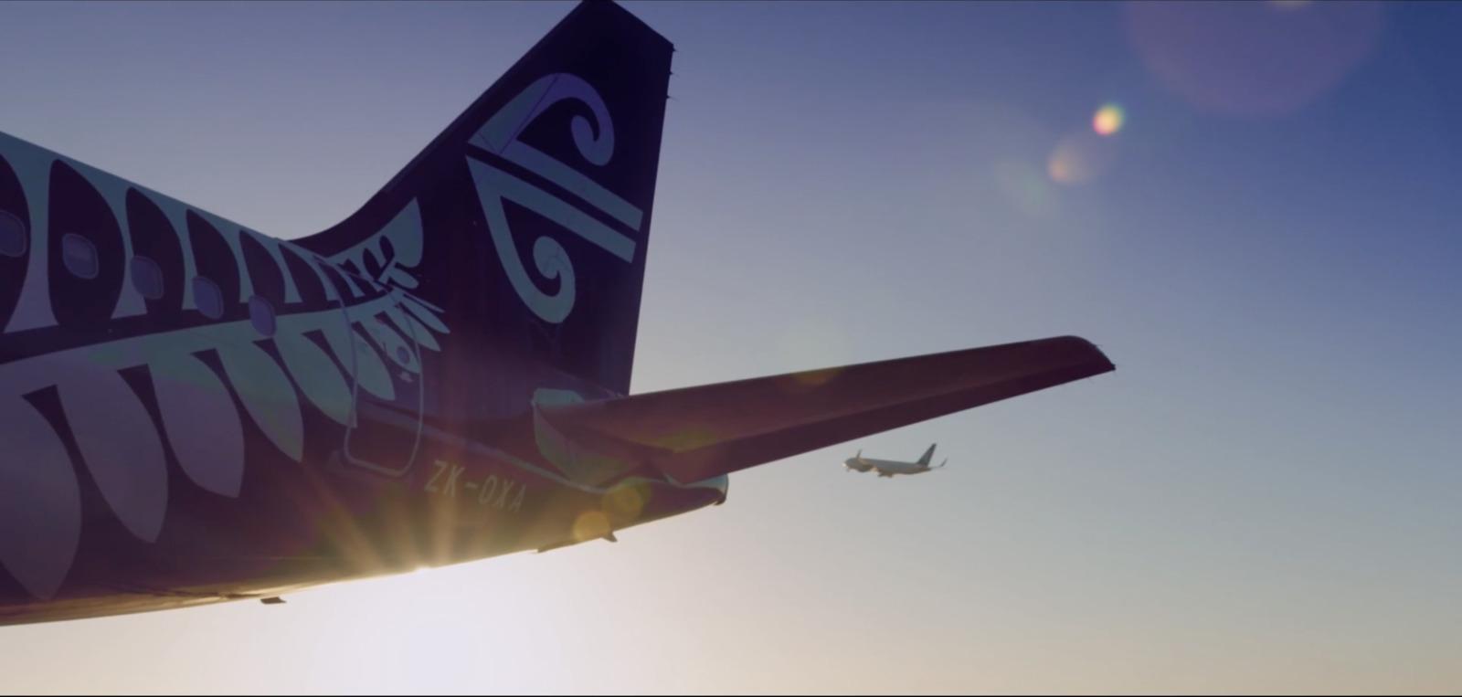 a large jetliner flying through a blue sky