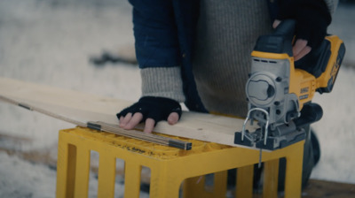 a person using a power tool on a piece of wood