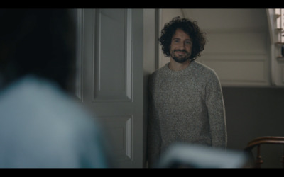 a man standing in front of a mirror in a room