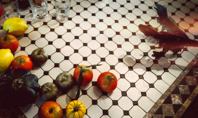 a bunch of fruits and vegetables on a tiled floor