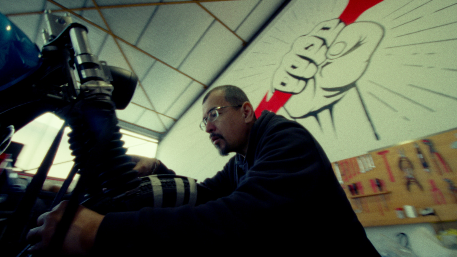 a man working on a motorcycle in a garage