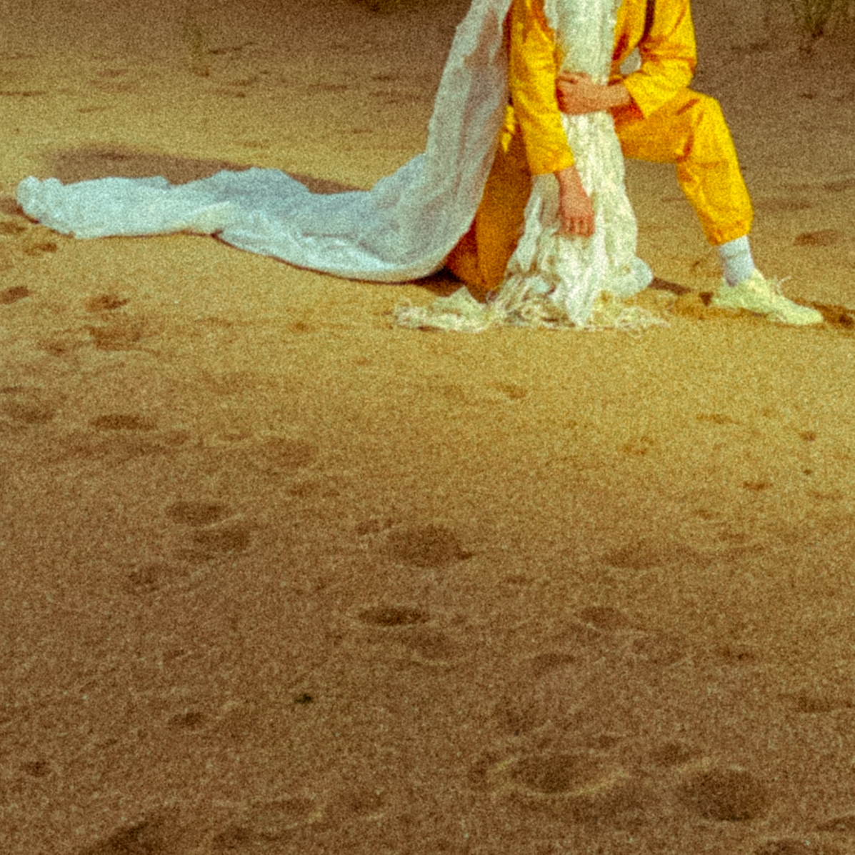 a man in a yellow suit and a woman in a white dress