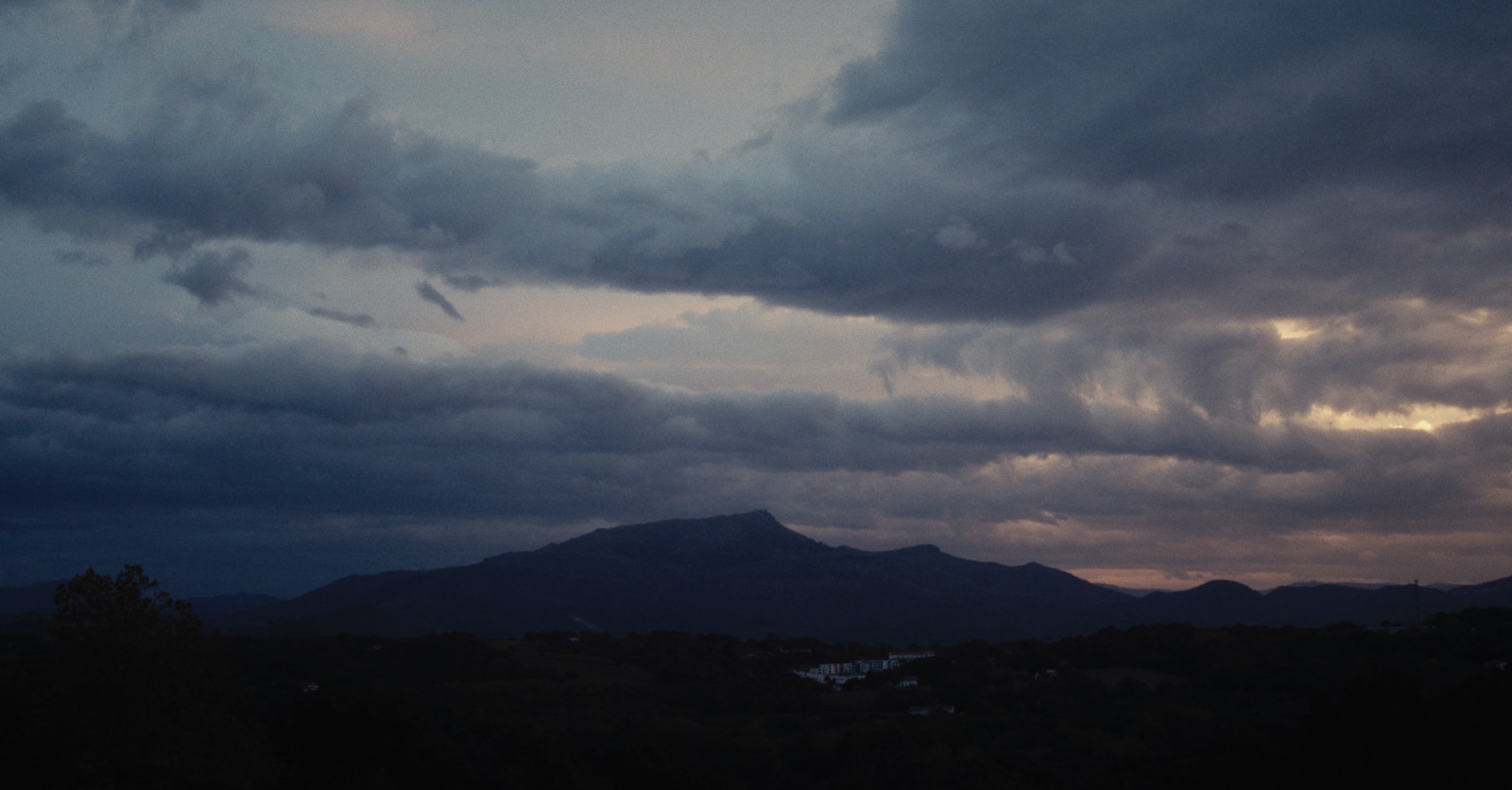 a view of a mountain range with clouds in the sky