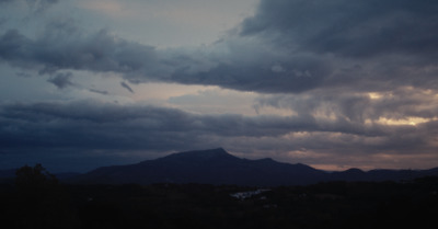 a view of a mountain range with clouds in the sky