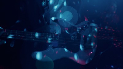 a blurry photo of a guitar in the dark