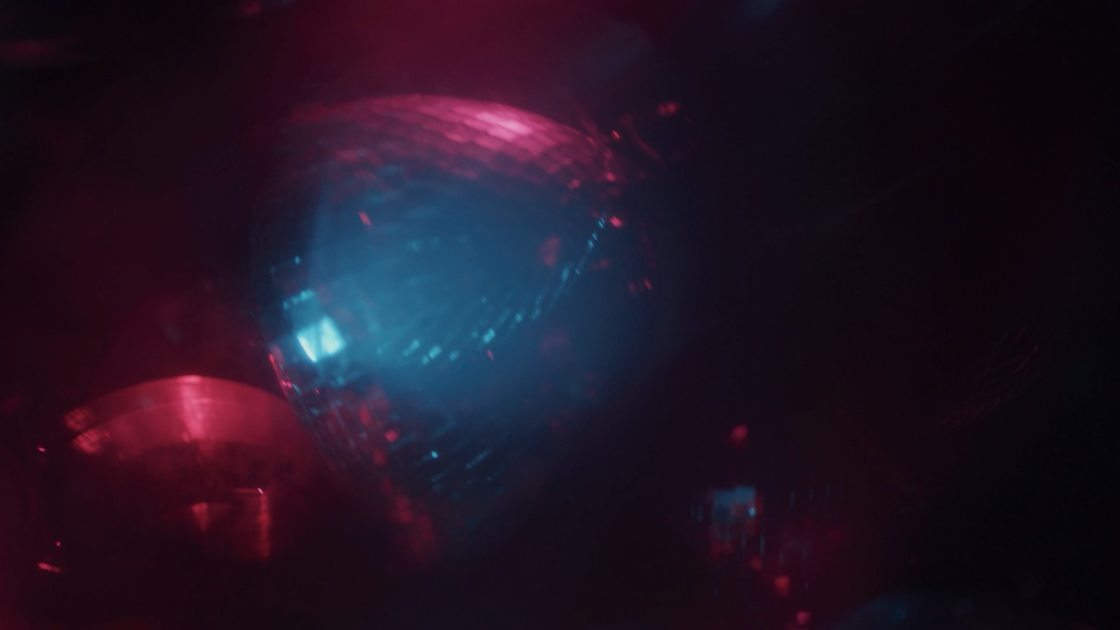 a blurry image of a disco ball in the dark