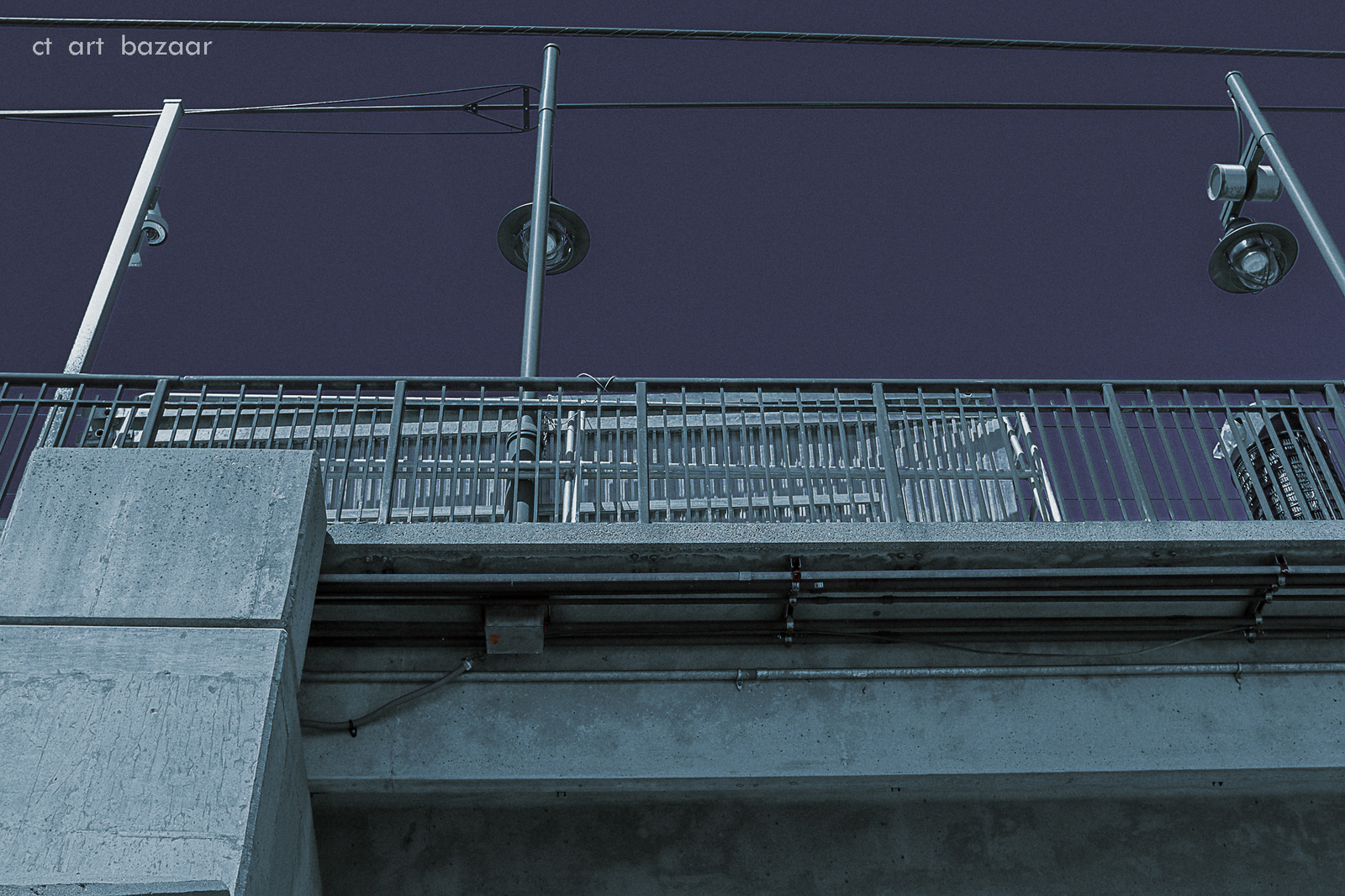 a traffic light hanging from the side of a bridge