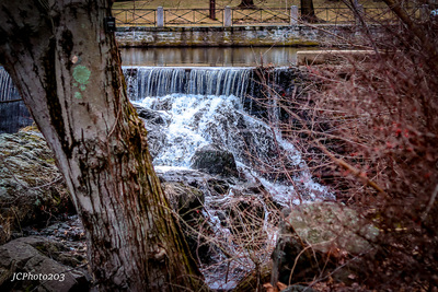 a small waterfall in the middle of a forest