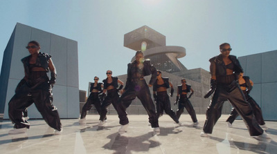 a group of men dancing in front of a building