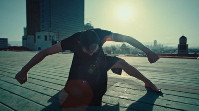 a man riding a skateboard on top of a wooden floor