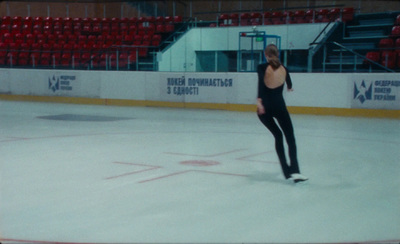 a woman is skating on an ice rink