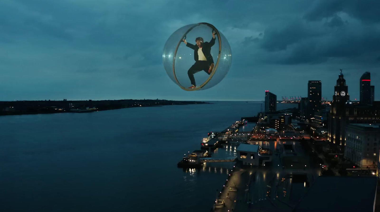  a man flying through the air on top of a glass ball