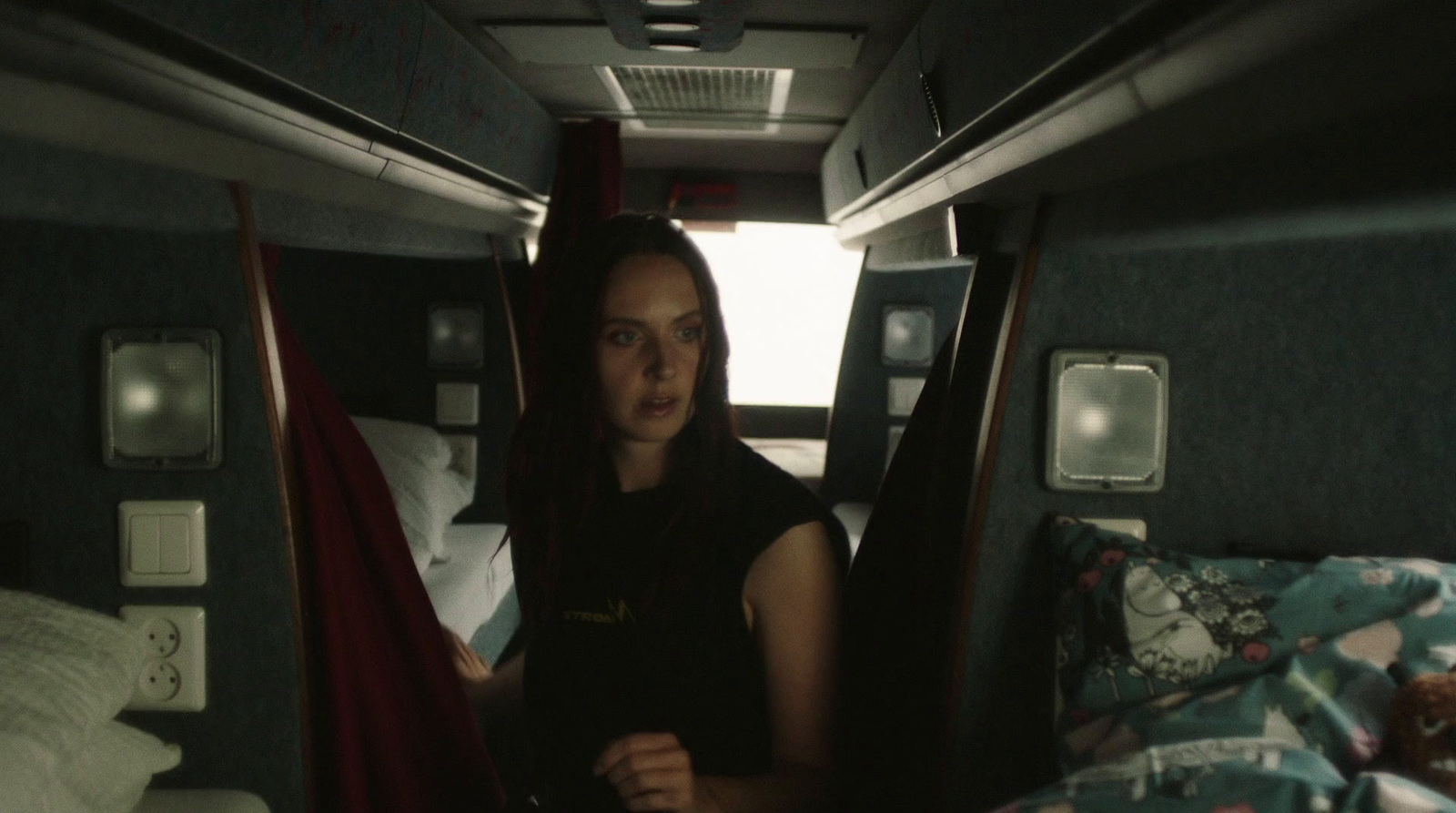 a woman is sitting in the back of a bus