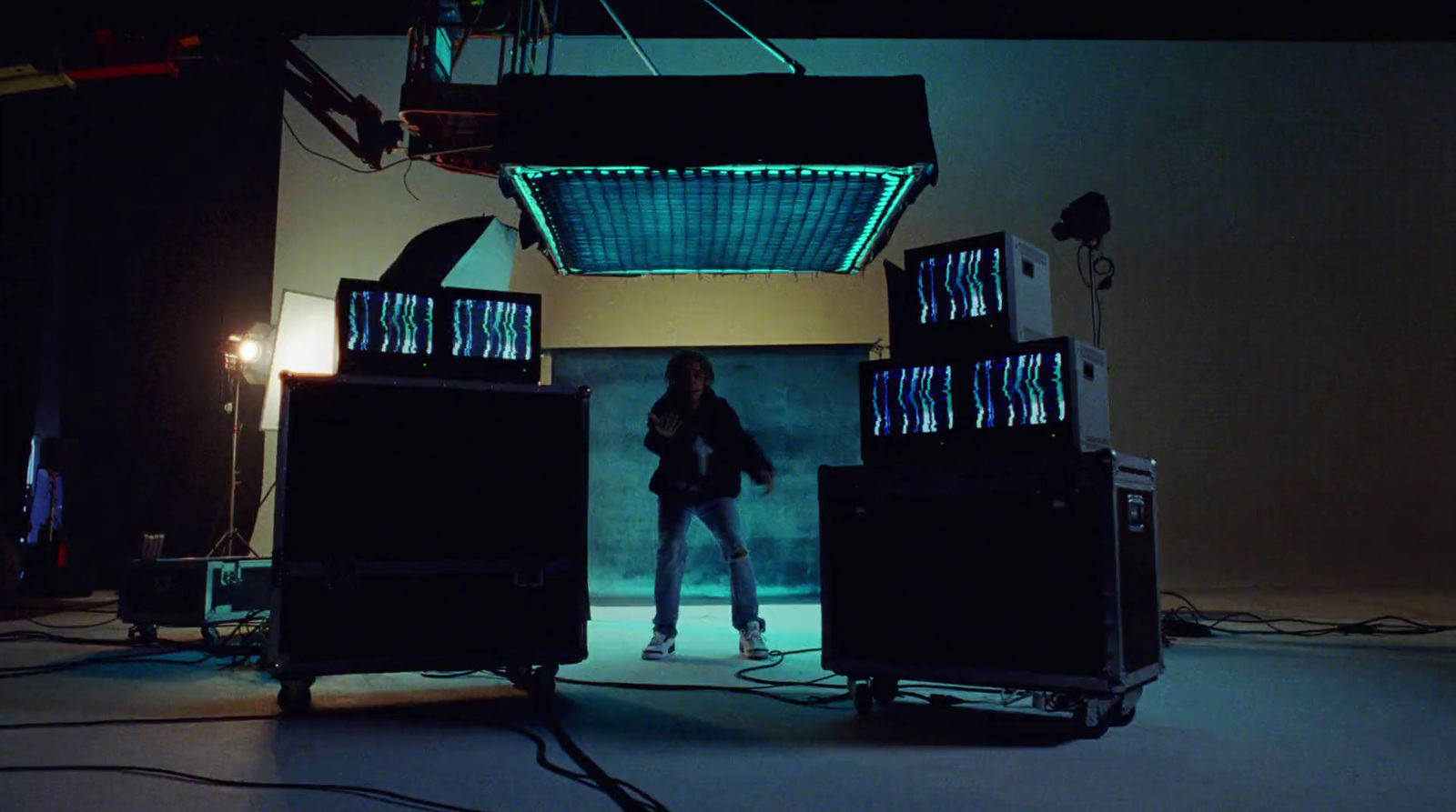 a woman standing in front of a set of speakers