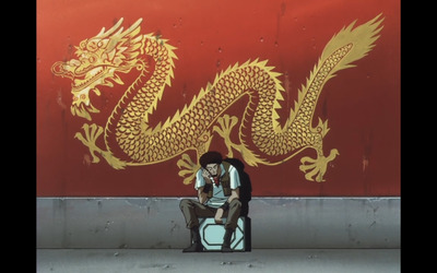 a man sitting on top of a suitcase next to a dragon