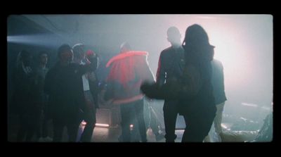 a group of people standing around in a dark room