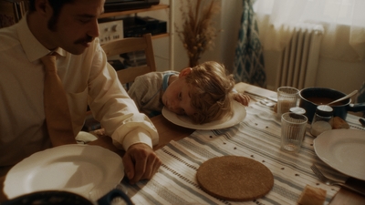 a man and a child sitting at a table