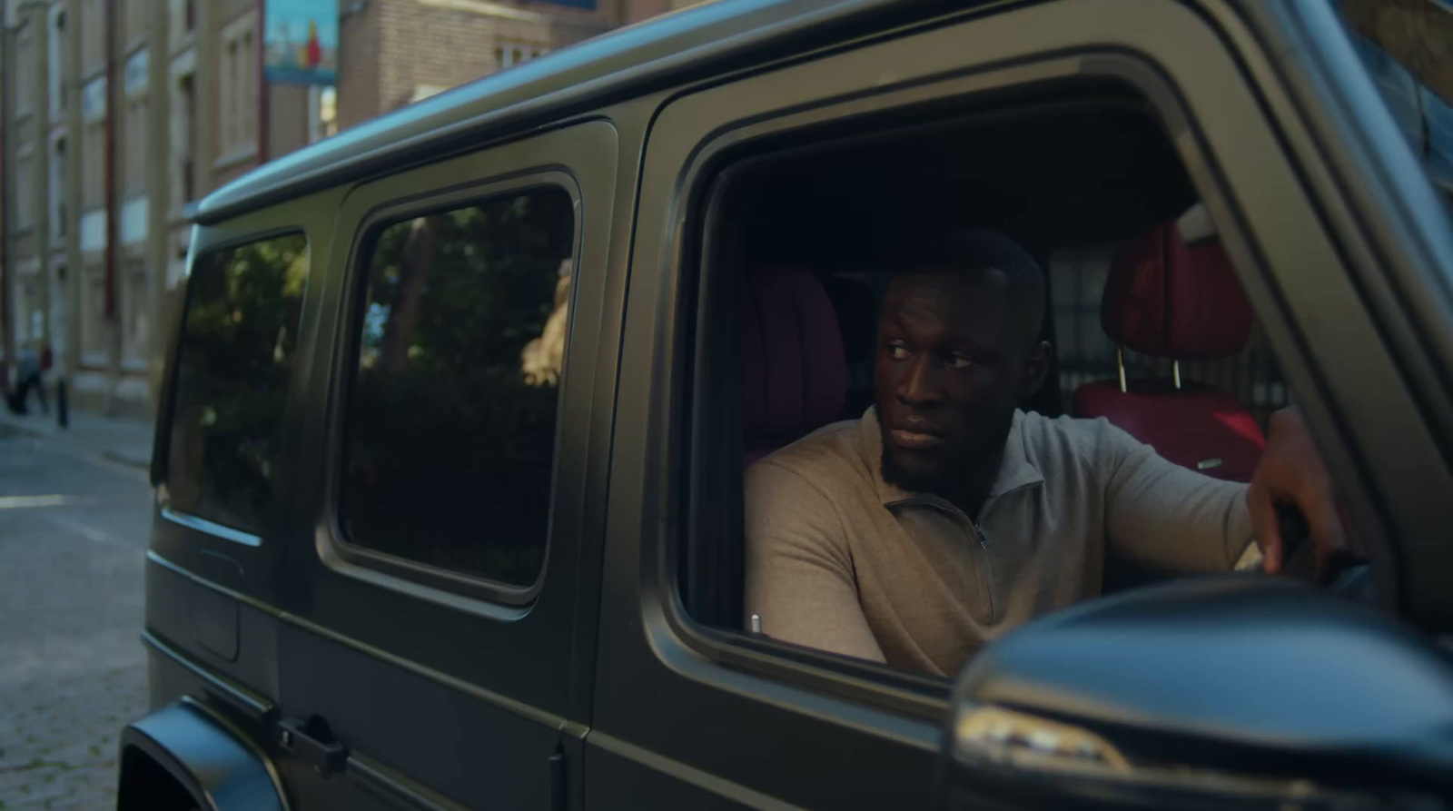 a man sitting in the driver's seat of a vehicle