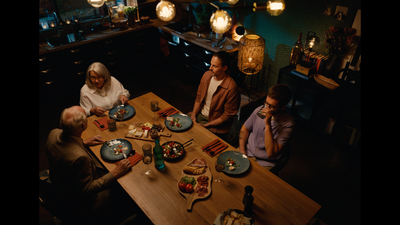 a group of people sitting around a table eating food