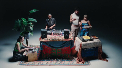 a group of people standing around a table