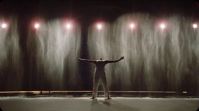 a man standing in front of a wall of water