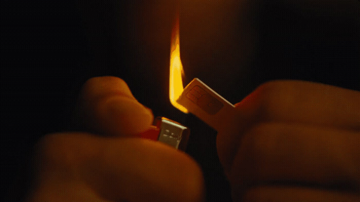 a person holding a lighter in their hand