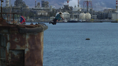 a person jumping in the air over a body of water