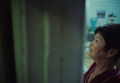 a woman standing in a kitchen looking up