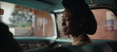 a woman sitting in the back seat of a car