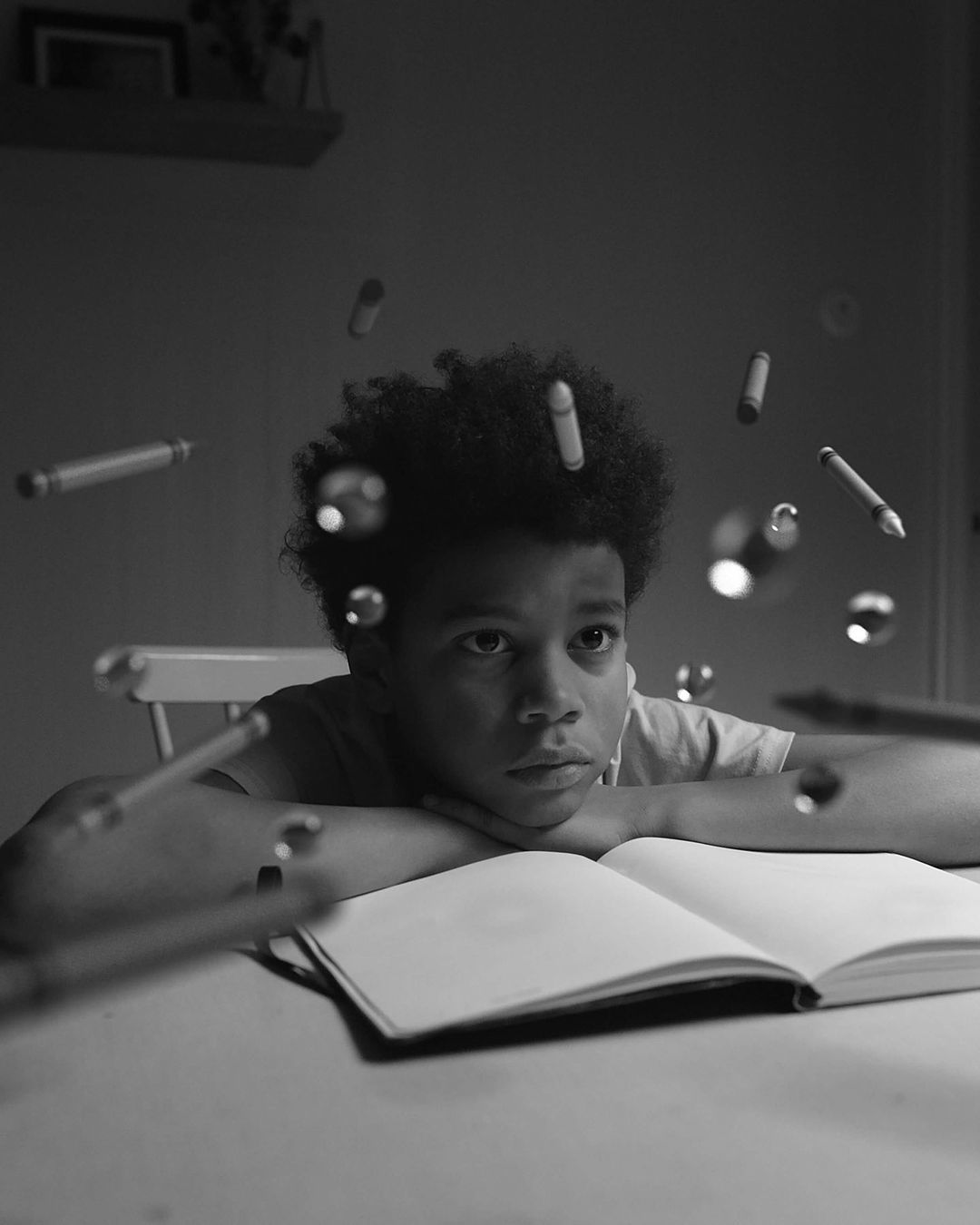 a person sitting at a table with an open book