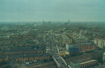 an aerial view of a city with a train on the tracks