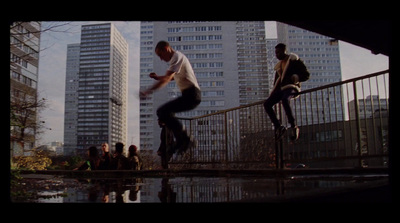 a man riding a skateboard down a metal hand rail