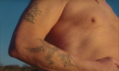 a close up of a man with a tattoo on his arm