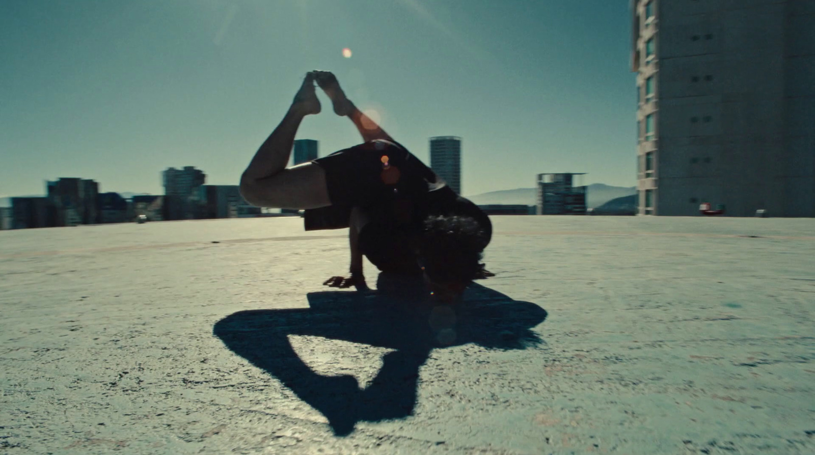 a person doing a handstand in the middle of a city