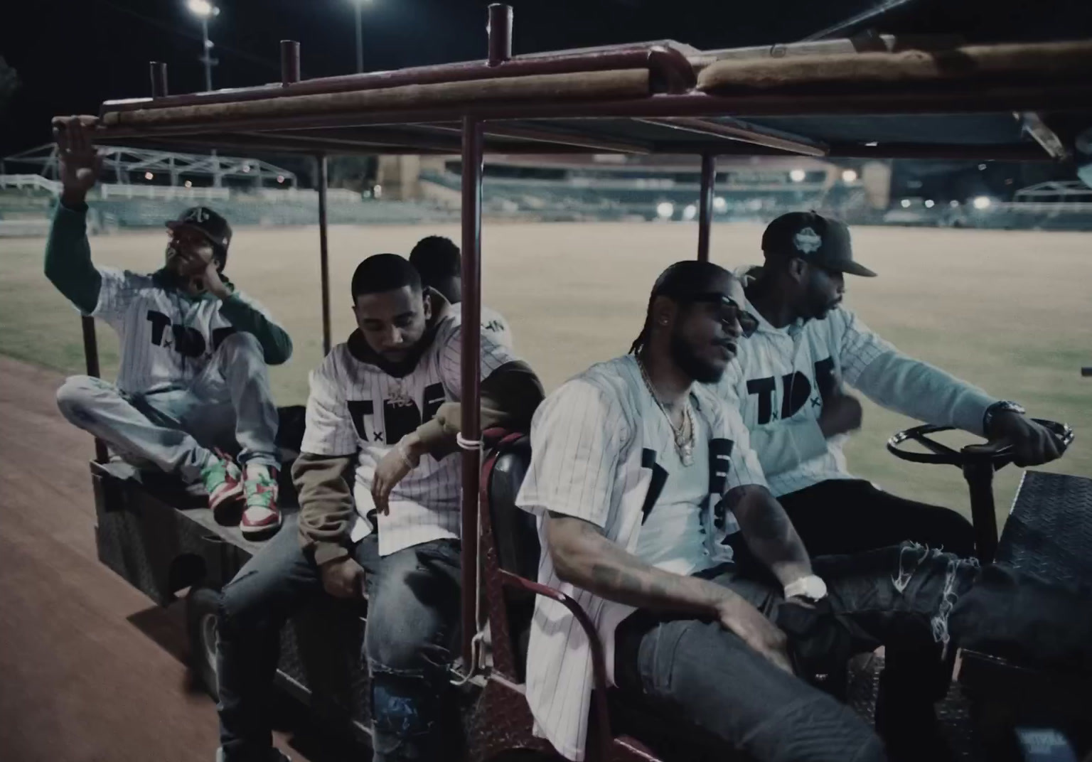 a group of men riding on the back of a bus