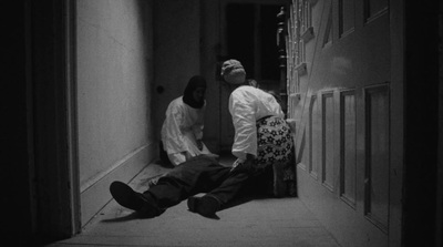 two men sitting on the floor in a hallway