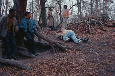 a group of people standing around a fallen tree