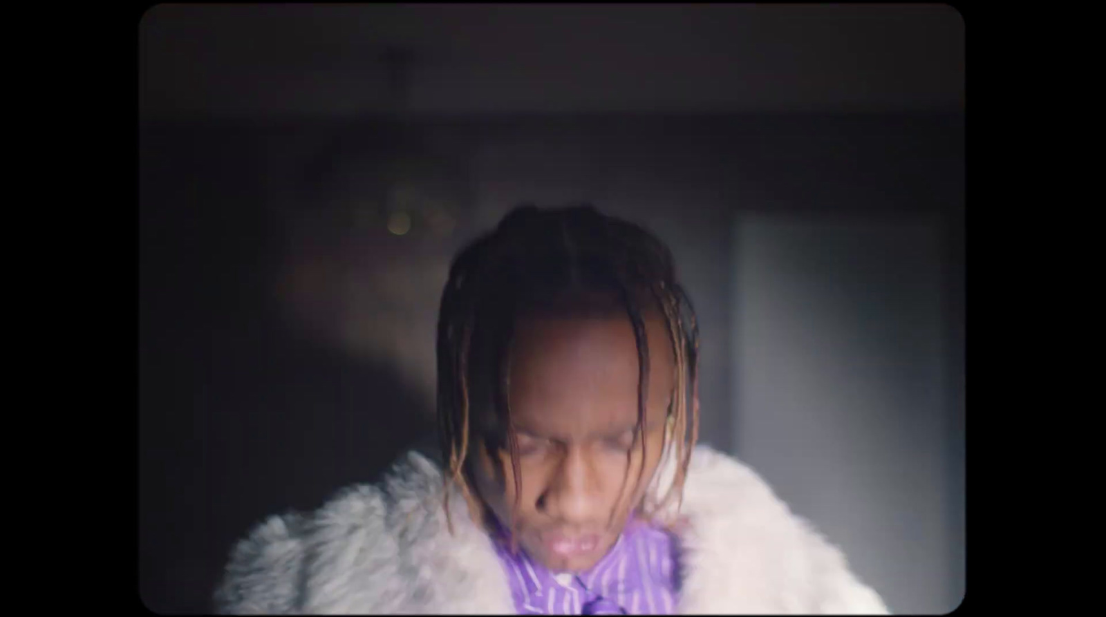 a man with dreadlocks and a purple bow tie