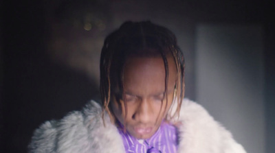 a man with dreadlocks and a purple tie