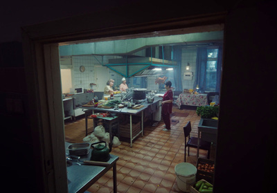 a group of people in a kitchen preparing food