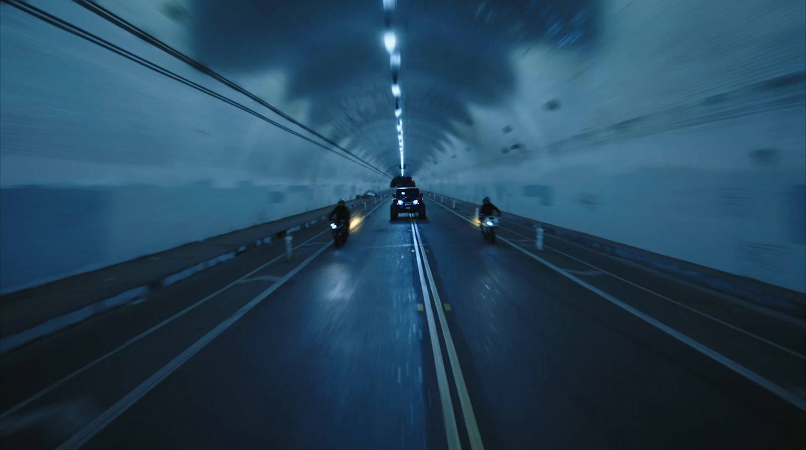 a car driving down a highway in a tunnel