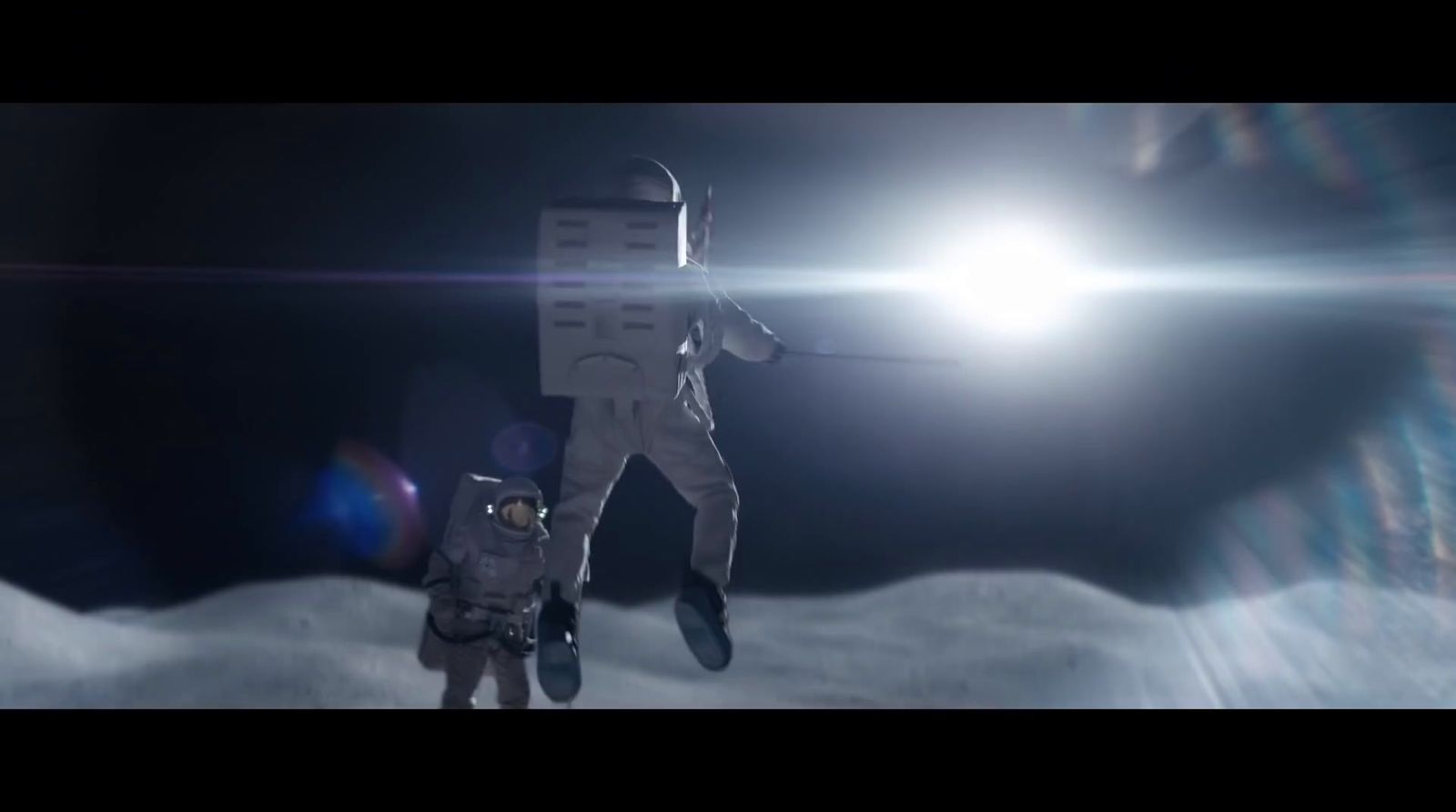 a man in a space suit standing next to another man