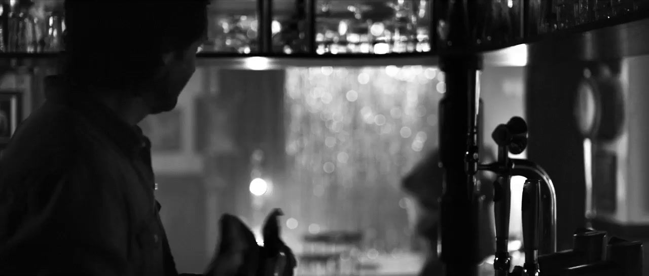 a man standing in a kitchen next to a window