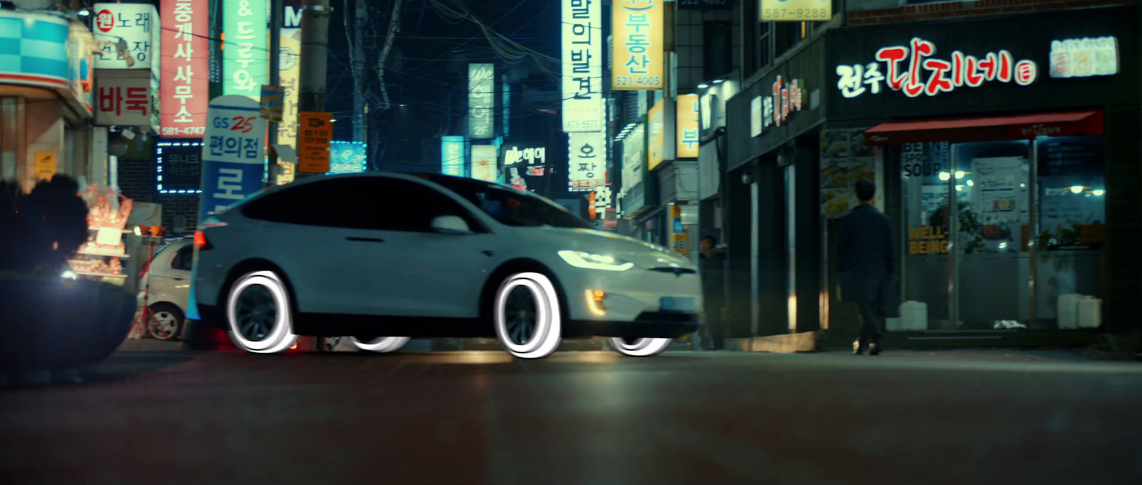 a car driving down a city street at night