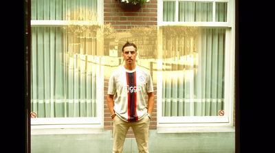 a man standing in front of a brick building