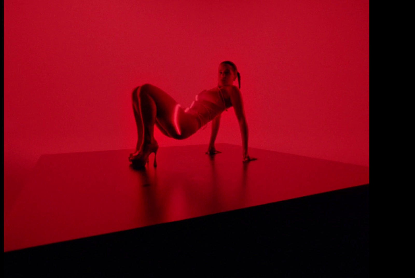 a woman laying on her back in a red room