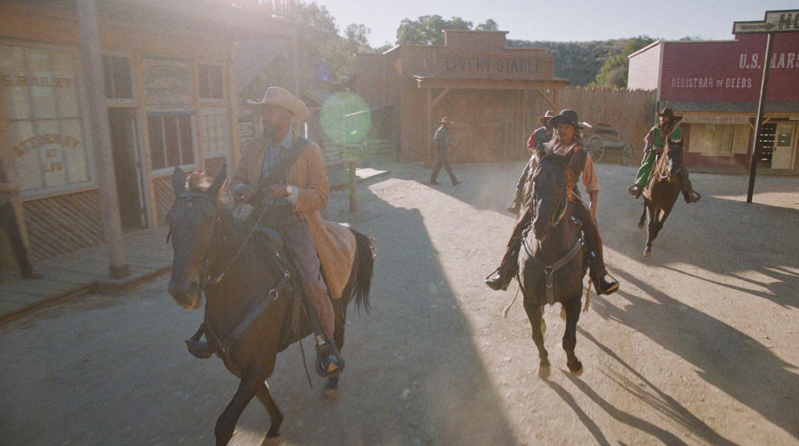 a group of people riding horses down a street