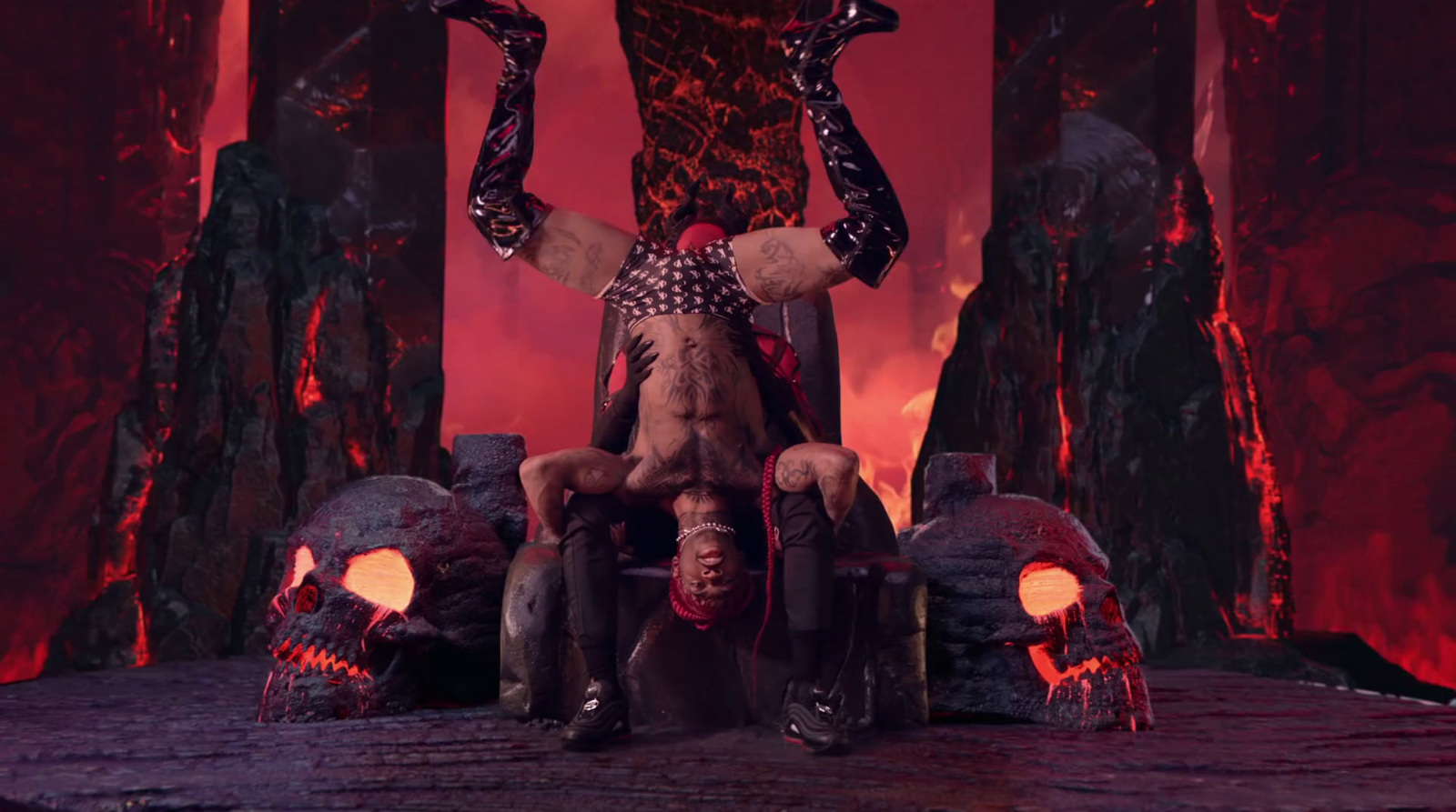 a man sitting on top of a chair in front of a fire