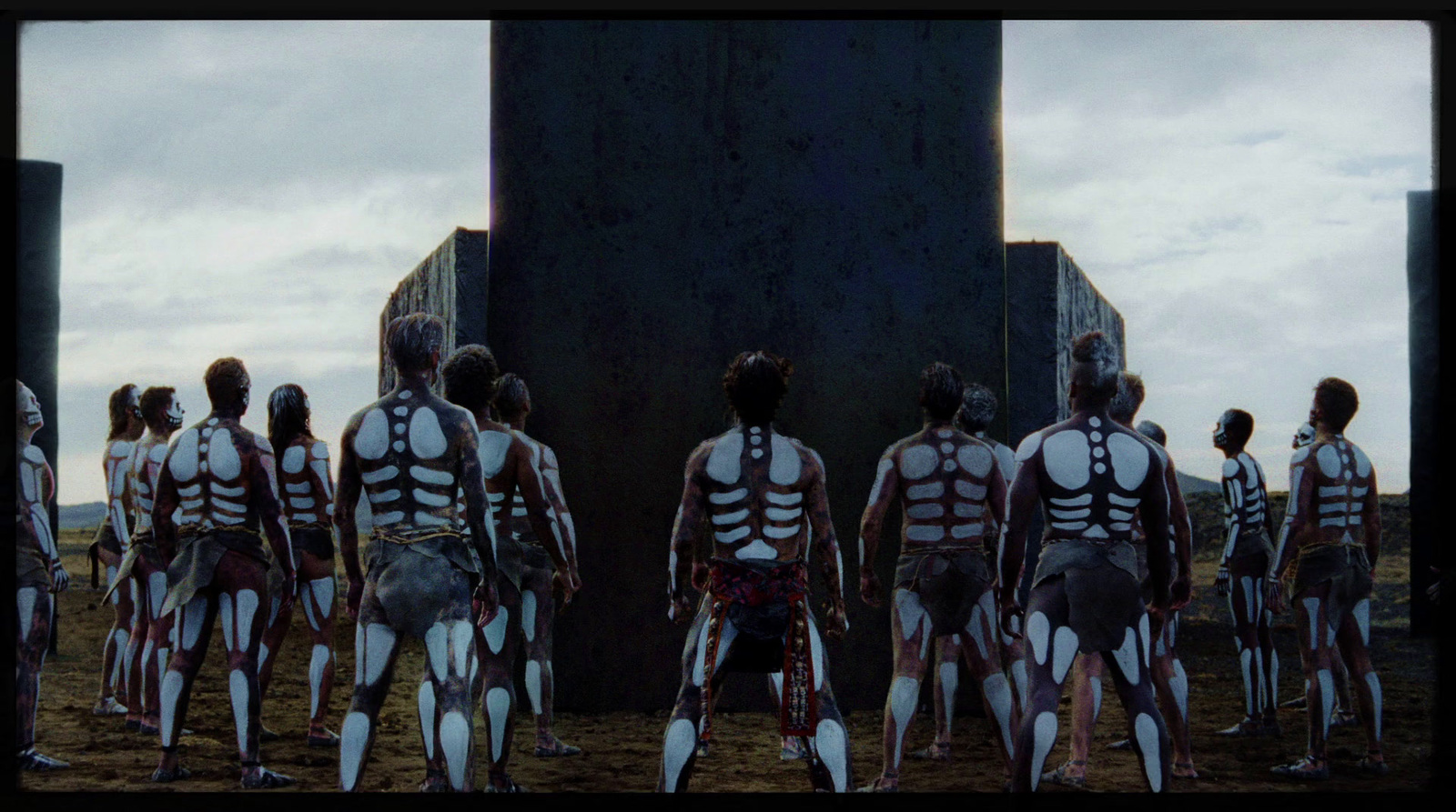 a group of people with skeleton body paint standing in front of a building