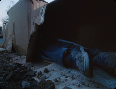 a person's feet sticking out of a pile of rubble